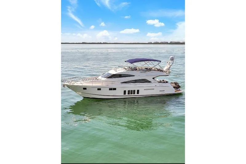  Yacht Photos Pics 2013 Fairline Squadron 66 yacht on calm water under blue sky.