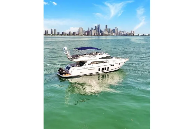  Yacht Photos Pics Luxury Fairline Squadron 66 yacht on water with city skyline backdrop, 2013 model.