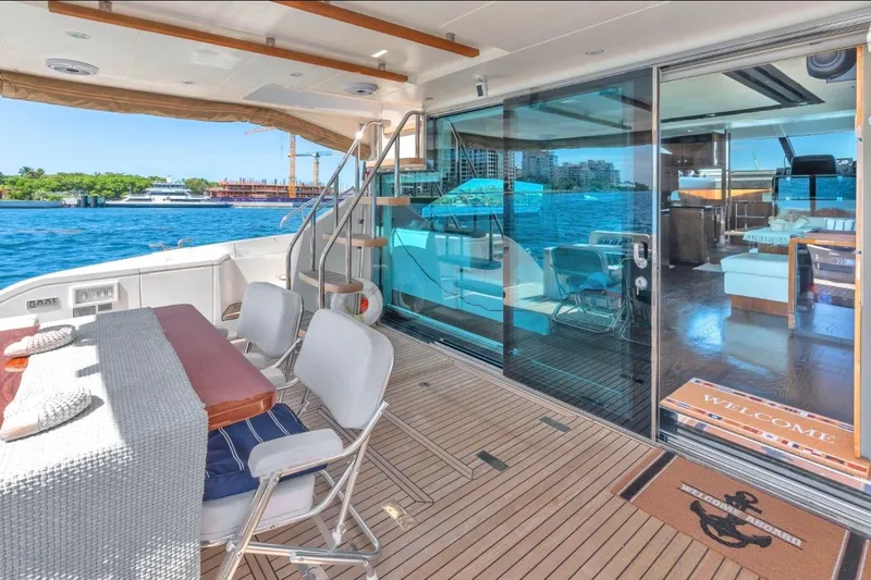  Yacht Photos Pics Luxurious 2013 Fairline Squadron 66 yacht with elegant outdoor seating and ocean view.