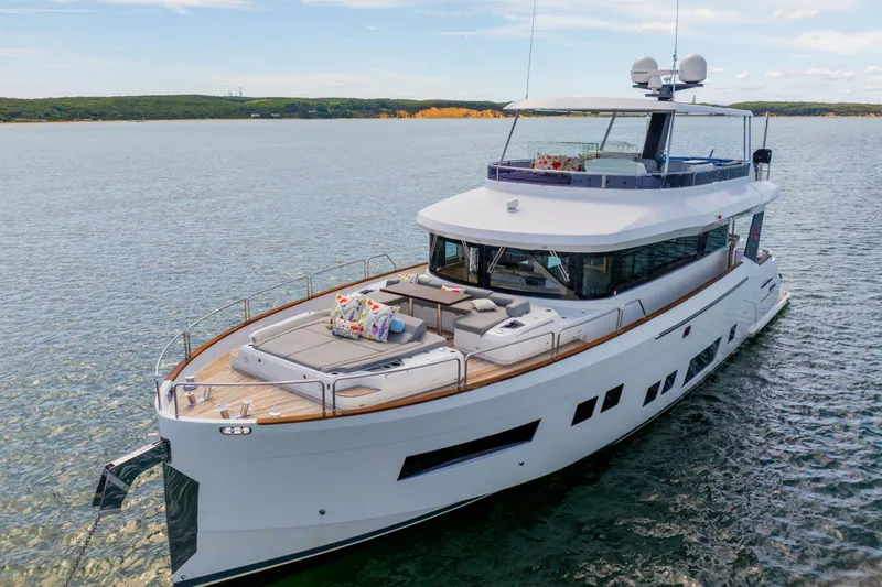 Amor Fati Yacht Photos Pics Luxurious 2019 Sirena 64 yacht cruising on serene waters, featuring spacious deck and modern design.
