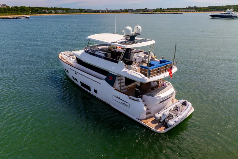 Amor Fati Yacht Photos Pics Luxurious 2019 Sirena 64 yacht cruising in serene waters, featuring spacious decks and modern design.