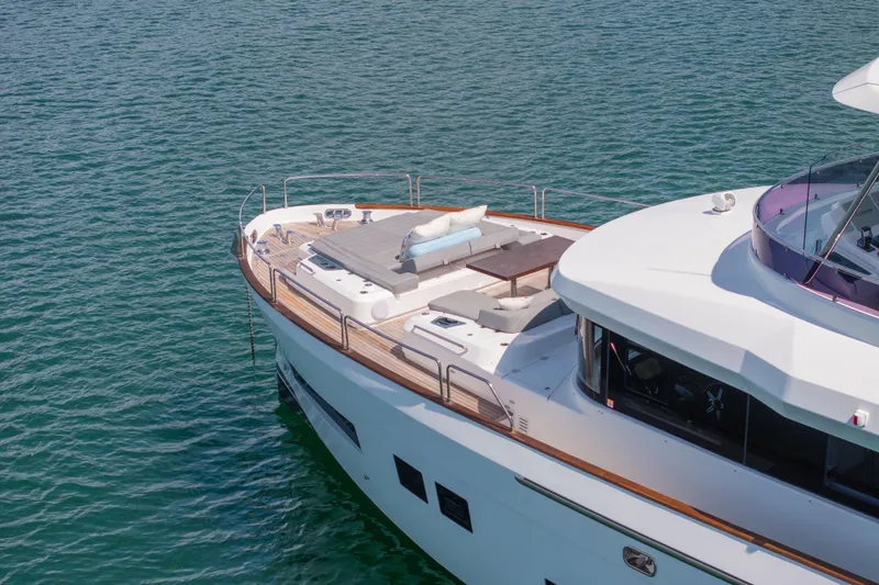 Amor Fati Yacht Photos Pics 2019 Sirena 64 yacht with spacious deck, cruising on calm blue waters.