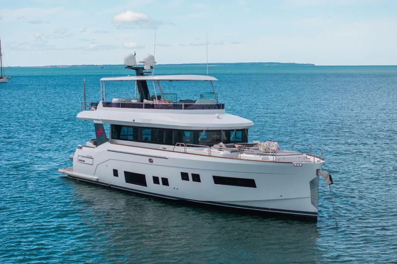 Amor Fati Yacht Photos Pics Luxurious 2019 Sirena 64 yacht cruising on calm blue waters.