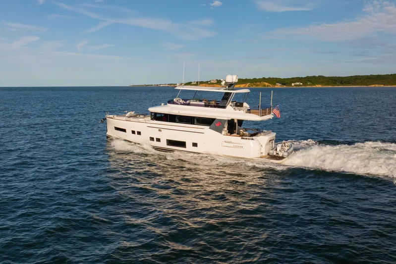 Amor Fati Yacht Photos Pics 2019 Sirena 64 yacht cruising on open water under a clear blue sky.