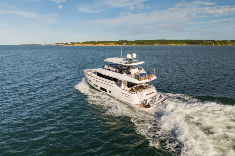 Amor Fati Yacht Photos Pics 2019 Sirena 64 yacht cruising on open water under a clear sky.