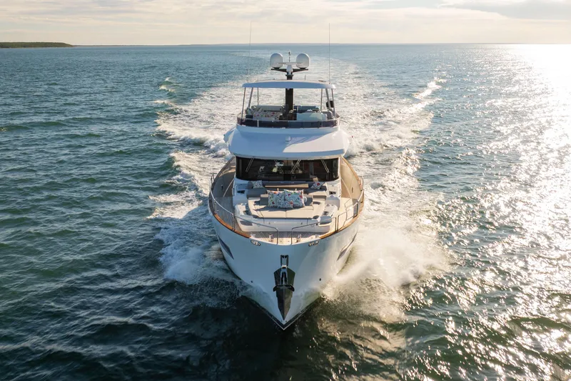 Amor Fati Yacht Photos Pics Luxurious 2019 Sirena 64 yacht cruising on open water under sunny skies.