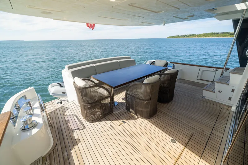 Amor Fati Yacht Photos Pics Luxurious 2019 Sirena 64 yacht deck with elegant seating and ocean view.