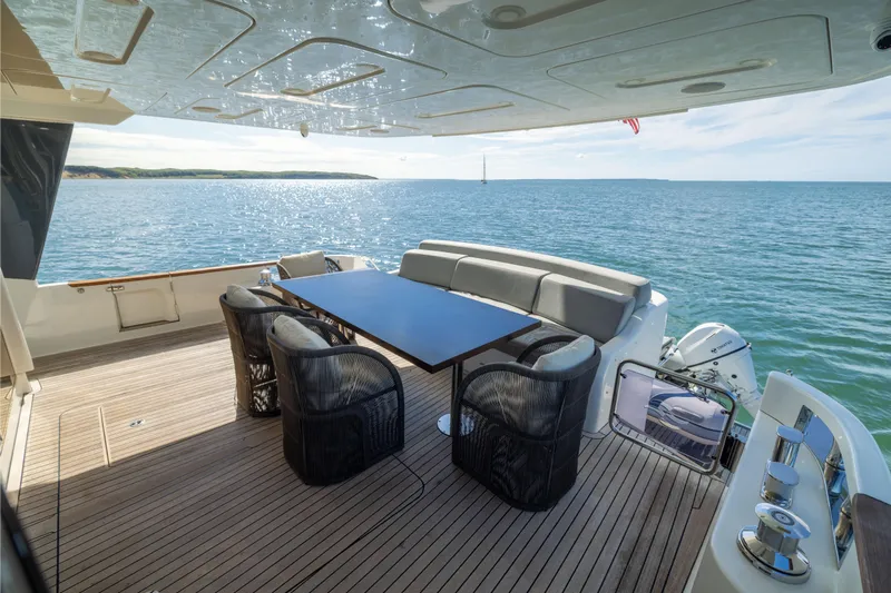 Amor Fati Yacht Photos Pics Luxurious 2019 Sirena 64 yacht deck with ocean view and elegant seating area.