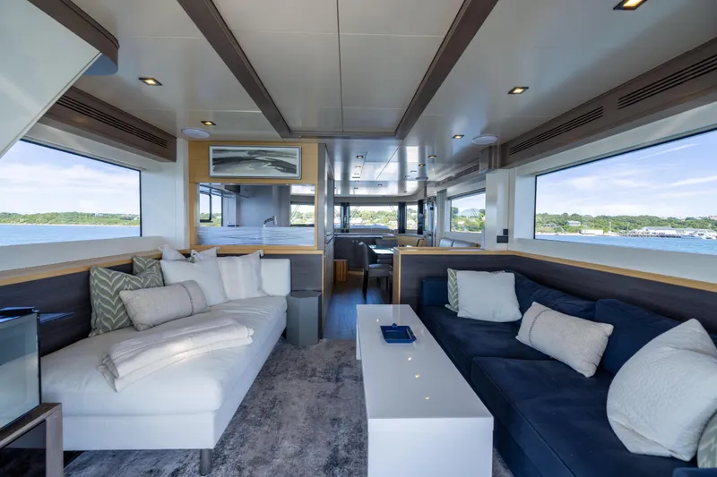 Amor Fati Yacht Photos Pics Luxurious interior of 2019 Sirena 64 yacht with modern seating and panoramic windows.