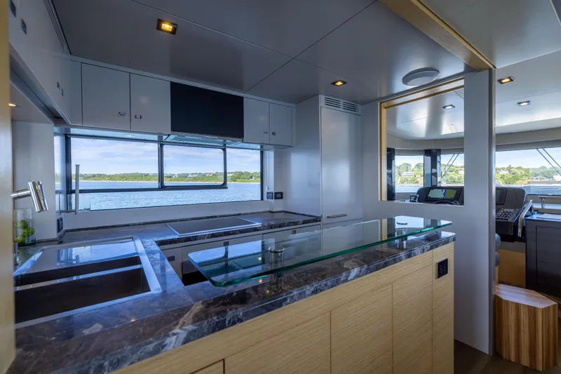 Amor Fati Yacht Photos Pics Modern kitchen interior on 2019 Sirena 64 yacht with scenic ocean view.