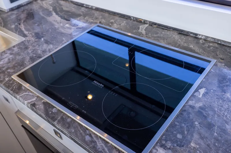 Amor Fati Yacht Photos Pics Modern induction cooktop on marble countertop in 2019 Sirena 64 yacht kitchen.
