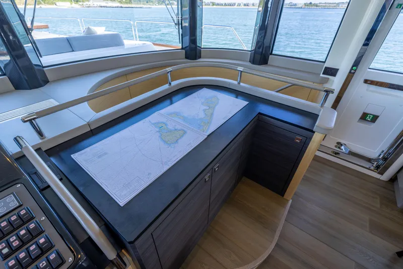 Amor Fati Yacht Photos Pics Luxurious interior of 2019 Sirena 64 yacht with navigation map on counter.