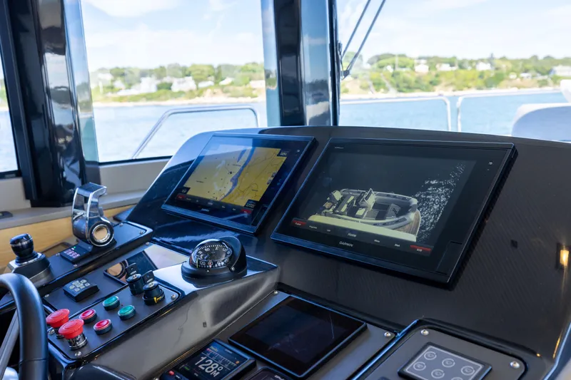 Amor Fati Yacht Photos Pics Cockpit of 2019 Sirena 64 yacht with navigation screens and controls.