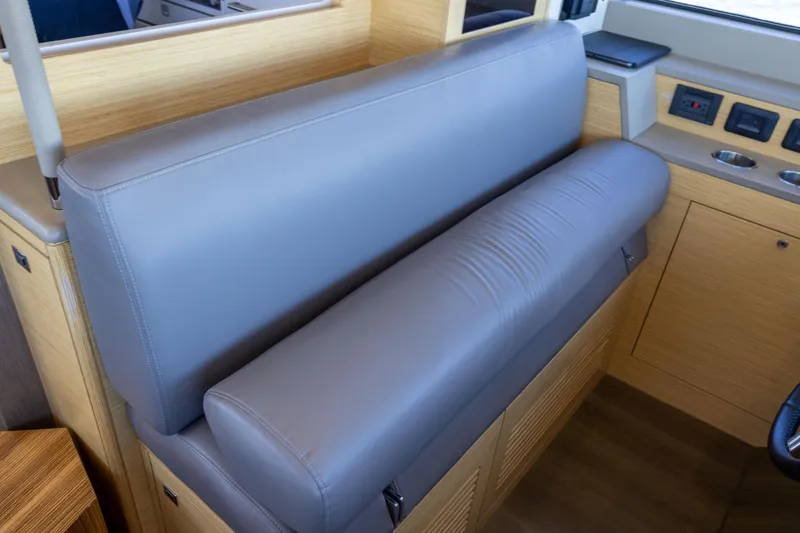 Amor Fati Yacht Photos Pics Luxurious interior seating of 2019 Sirena 64 yacht with sleek gray upholstery.