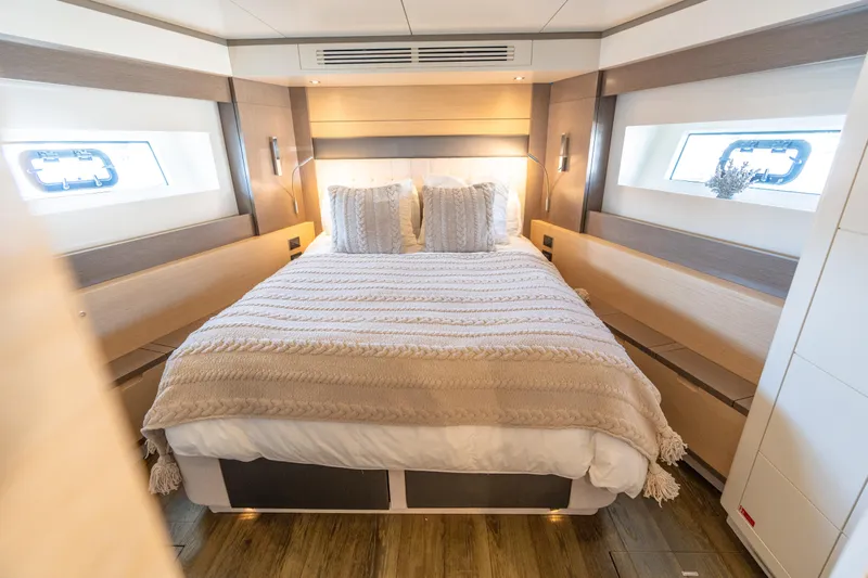 Amor Fati Yacht Photos Pics Luxurious bedroom interior of 2019 Sirena 64 yacht with cozy bedding and modern design.