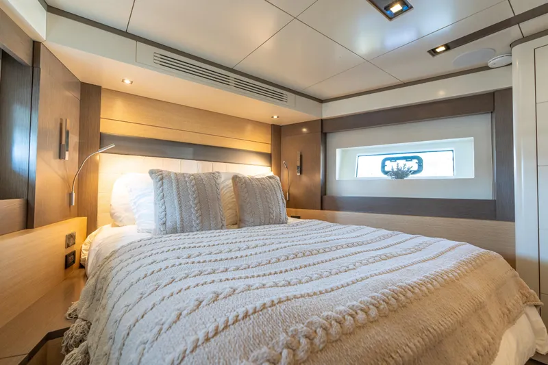Amor Fati Yacht Photos Pics Luxurious bedroom interior of 2019 Sirena 64 yacht with cozy bedding and modern design.