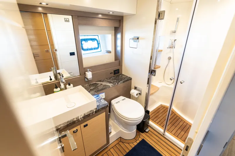 Amor Fati Yacht Photos Pics Luxurious bathroom in 2019 Sirena 64 yacht with modern fixtures and wooden flooring.