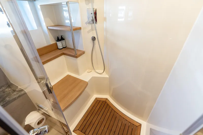 Amor Fati Yacht Photos Pics Luxurious Sirena 64 yacht shower with wooden accents and modern fixtures, 2019 model.