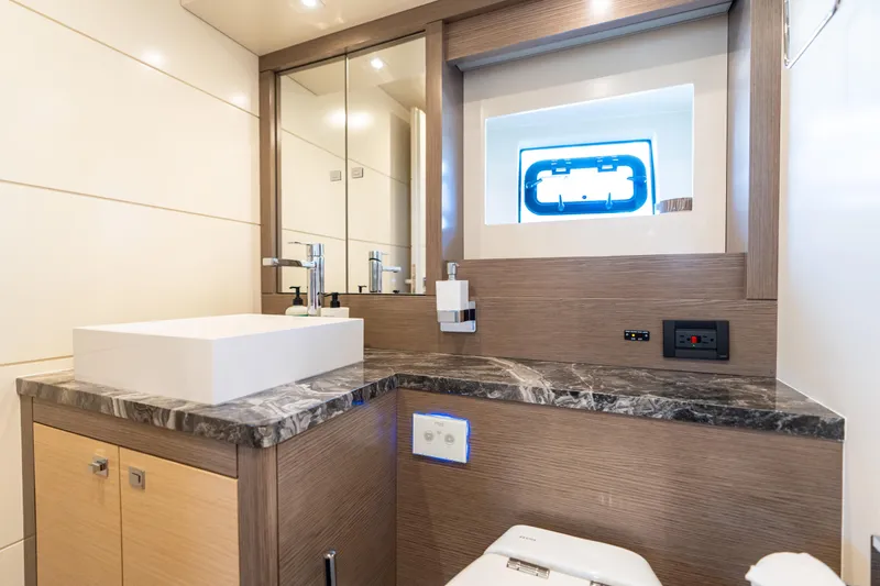 Amor Fati Yacht Photos Pics Luxurious bathroom interior on 2019 Sirena 64 yacht with modern fixtures and marble countertop.