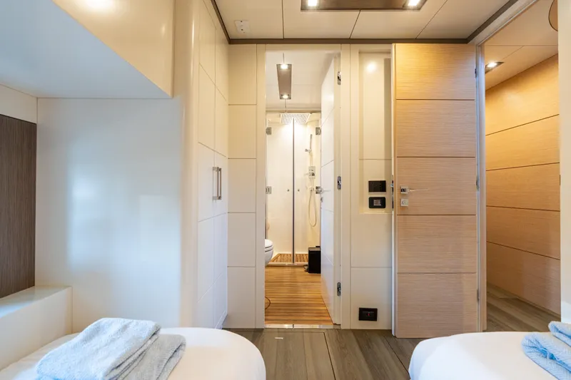 Amor Fati Yacht Photos Pics Luxurious interior of 2019 Sirena 64 yacht featuring modern bathroom and cozy bedroom.
