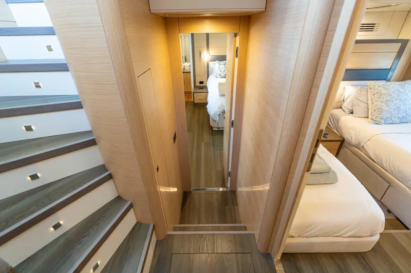 Amor Fati Yacht Photos Pics Luxurious interior of 2019 Sirena 64 yacht, featuring elegant wood finishes and cozy bedrooms.