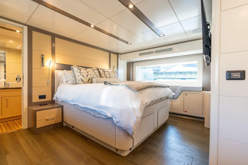 Amor Fati Yacht Photos Pics Luxurious bedroom interior of 2019 Sirena 64 yacht with modern design and large window.