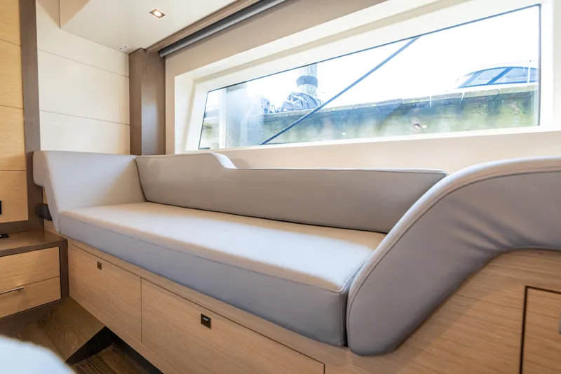 Amor Fati Yacht Photos Pics Luxurious interior of 2019 Sirena 64 yacht with elegant seating and large window.
