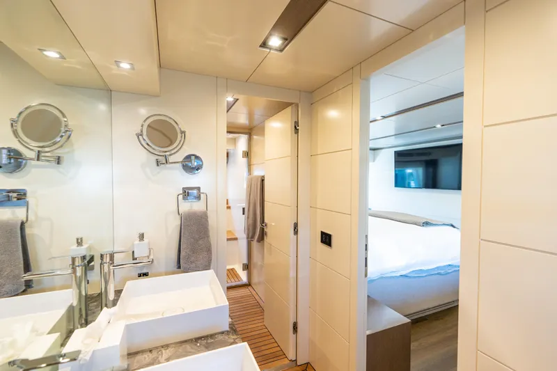 Amor Fati Yacht Photos Pics Luxurious bathroom and bedroom interior of 2019 Sirena 64 yacht, featuring modern fixtures and elegant design.