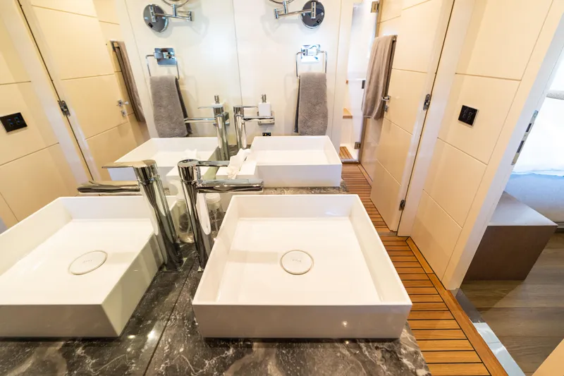 Amor Fati Yacht Photos Pics Luxurious bathroom in 2019 Sirena 64 yacht with dual sinks and elegant fixtures.