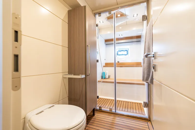 Amor Fati Yacht Photos Pics Luxurious bathroom in 2019 Sirena 64 yacht with modern shower and wooden flooring.