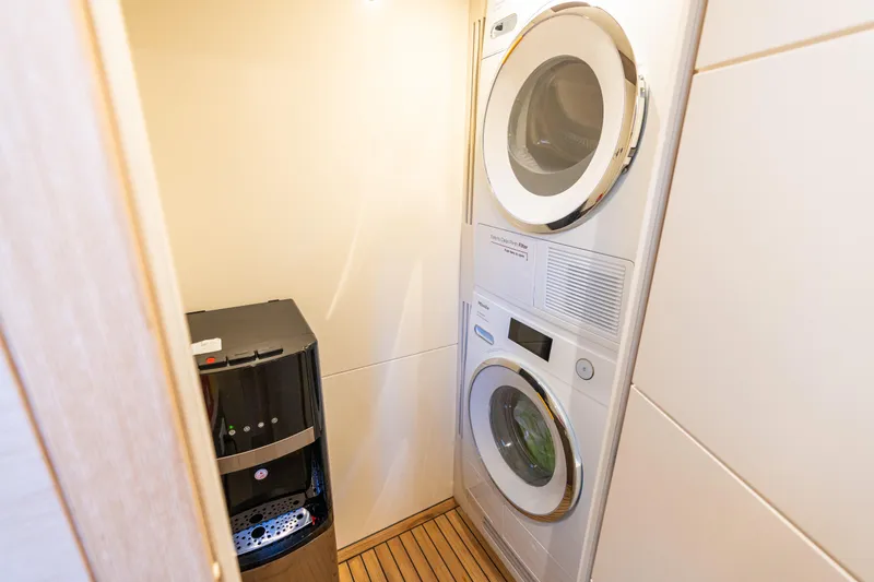 Amor Fati Yacht Photos Pics Laundry area in 2019 Sirena 64 yacht with washer, dryer, and water dispenser.