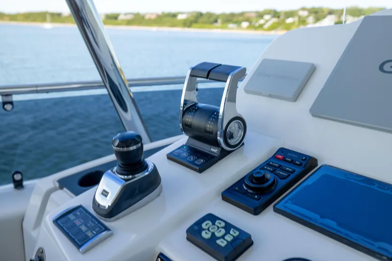 Amor Fati Yacht Photos Pics Cockpit controls of 2019 Sirena 64 yacht with navigation equipment and throttle levers.
