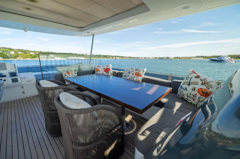 Amor Fati Yacht Photos Pics Luxurious 2019 Sirena 64 yacht deck with elegant seating and scenic ocean view.