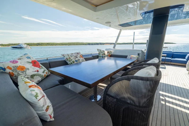 Amor Fati Yacht Photos Pics Luxurious 2019 Sirena 64 yacht deck with elegant seating and scenic ocean view.