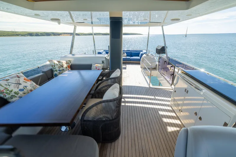 Amor Fati Yacht Photos Pics Luxurious 2019 Sirena 64 yacht deck with elegant seating and ocean view.