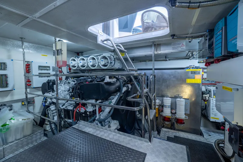 Amor Fati Yacht Photos Pics Engine room of 2019 Sirena 64 yacht, showcasing machinery and equipment.