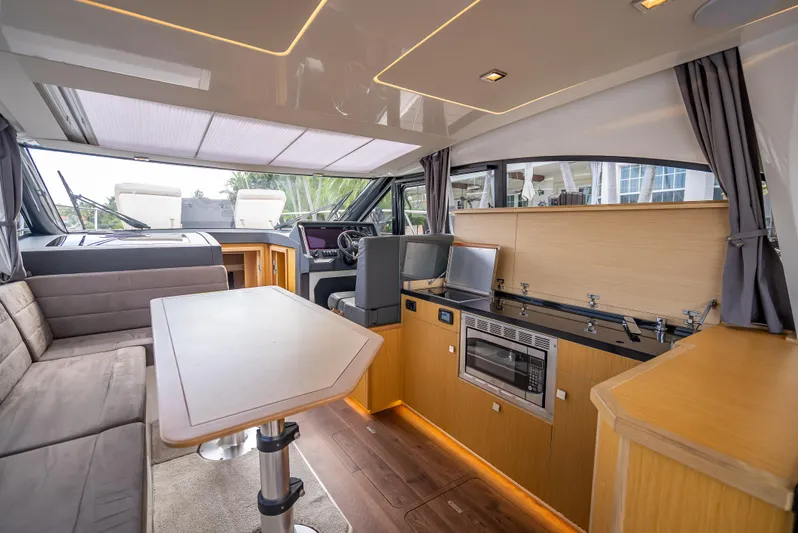  Yacht Photos Pics Luxurious interior of 2021 Skamander Monaco yacht with modern kitchen and seating area.