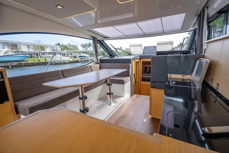 Yacht Photos Pics Luxurious interior of 2021 Skamander Monaco yacht with modern seating and dining area.