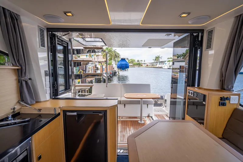  Yacht Photos Pics Interior view of 2021 Skamander Monaco yacht with open deck and waterfront scenery.