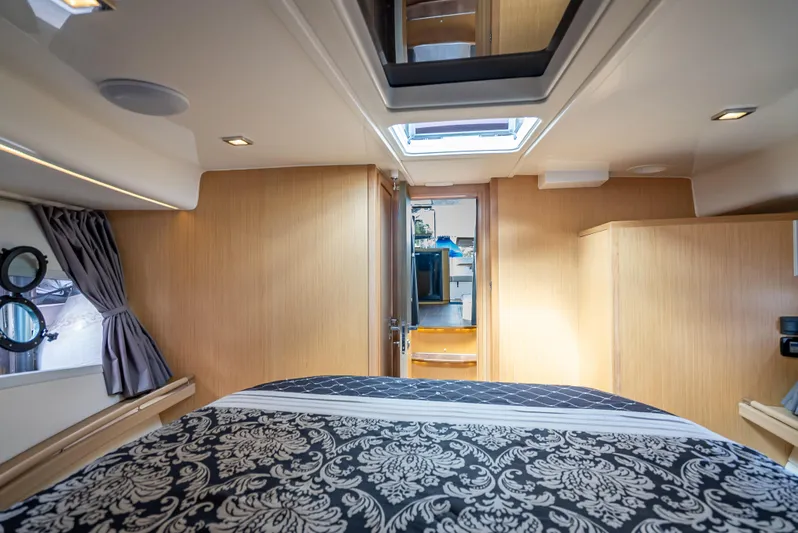  Yacht Photos Pics Luxurious interior of 2021 Skamander Monaco yacht with elegant bedding and wood paneling.