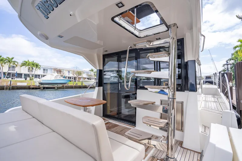  Yacht Photos Pics Luxurious 2021 Skamander Monaco yacht with modern interior and spiral staircase, docked by waterfront homes.