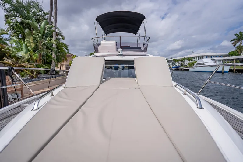  Yacht Photos Pics Luxury Skamander Monaco 2021 yacht with sunbathing deck, docked by palm trees and waterfront homes.