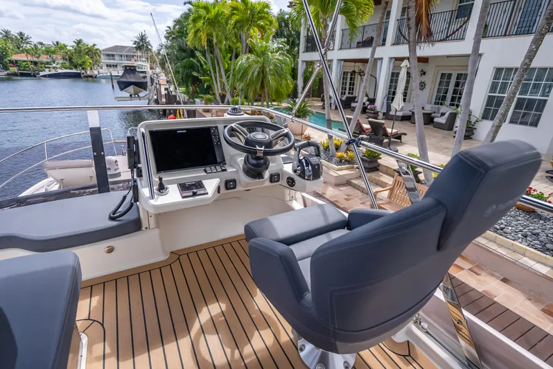  Yacht Photos Pics Luxury Skamander Monaco 2021 yacht helm with modern controls, docked by waterfront property.