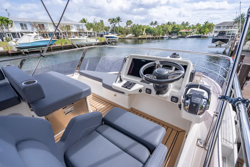  Yacht Photos Pics 2021 Skamander Monaco yacht cockpit with modern controls, luxurious seating, and scenic marina view.