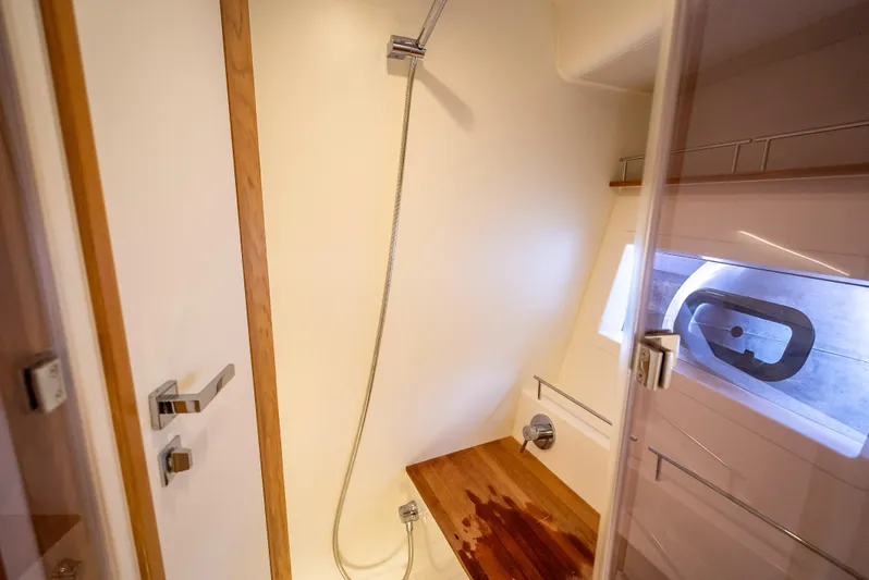  Yacht Photos Pics Modern shower area in 2021 Skamander Monaco yacht with wooden bench and window.