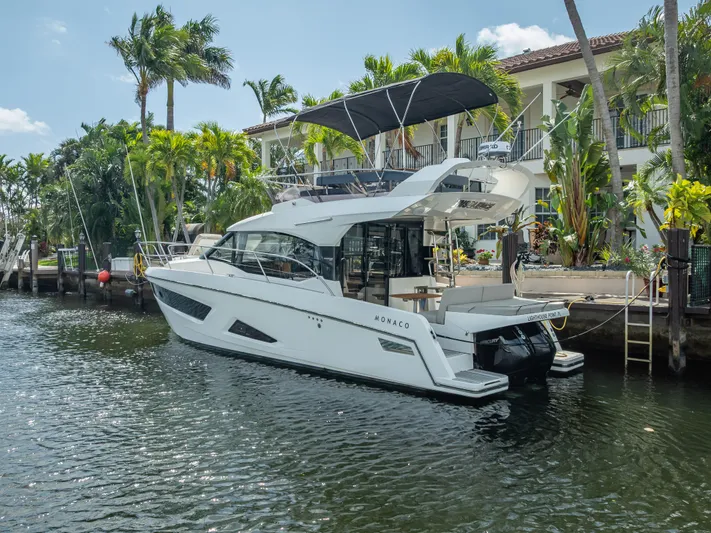  Yacht Photos Pics 2021 Skamander Monaco yacht docked by tropical waterfront, featuring sleek design and modern amenities.