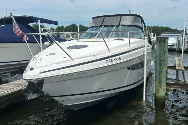 Qtech-1 Yacht Photos Pics 2015 Regal 32 Express boat docked at marina, featuring sleek design and white exterior.