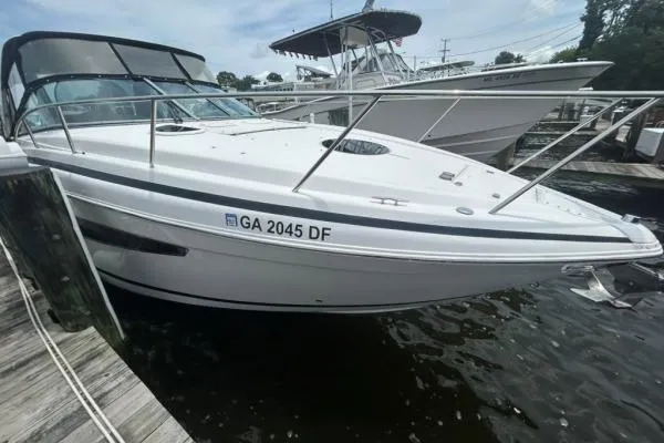 Qtech-1 Yacht Photos Pics 2015 Regal 32 Express boat docked at marina, side view.