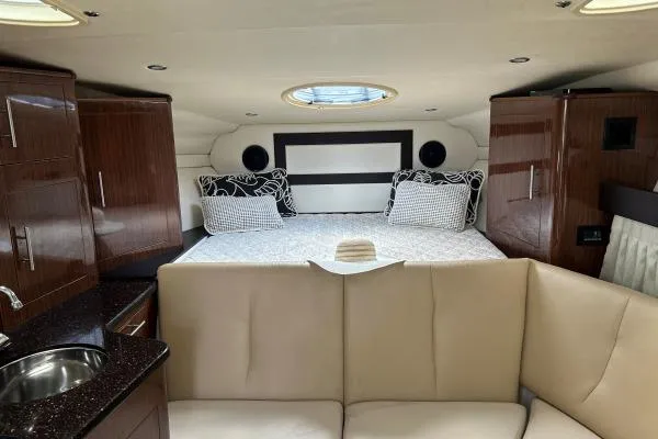 Qtech-1 Yacht Photos Pics Luxurious interior of 2015 Regal 32 Express yacht with cozy bed and elegant cabinetry.