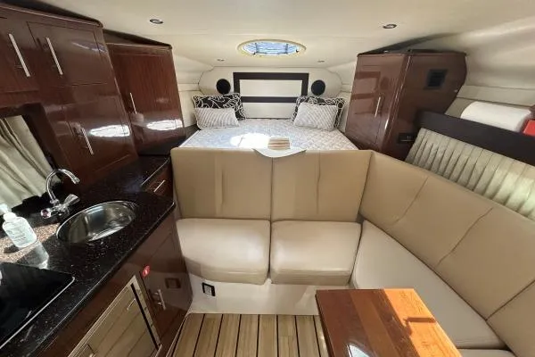 Qtech-1 Yacht Photos Pics Luxurious interior of 2015 Regal 32 Express yacht with cozy seating and elegant wood finishes.